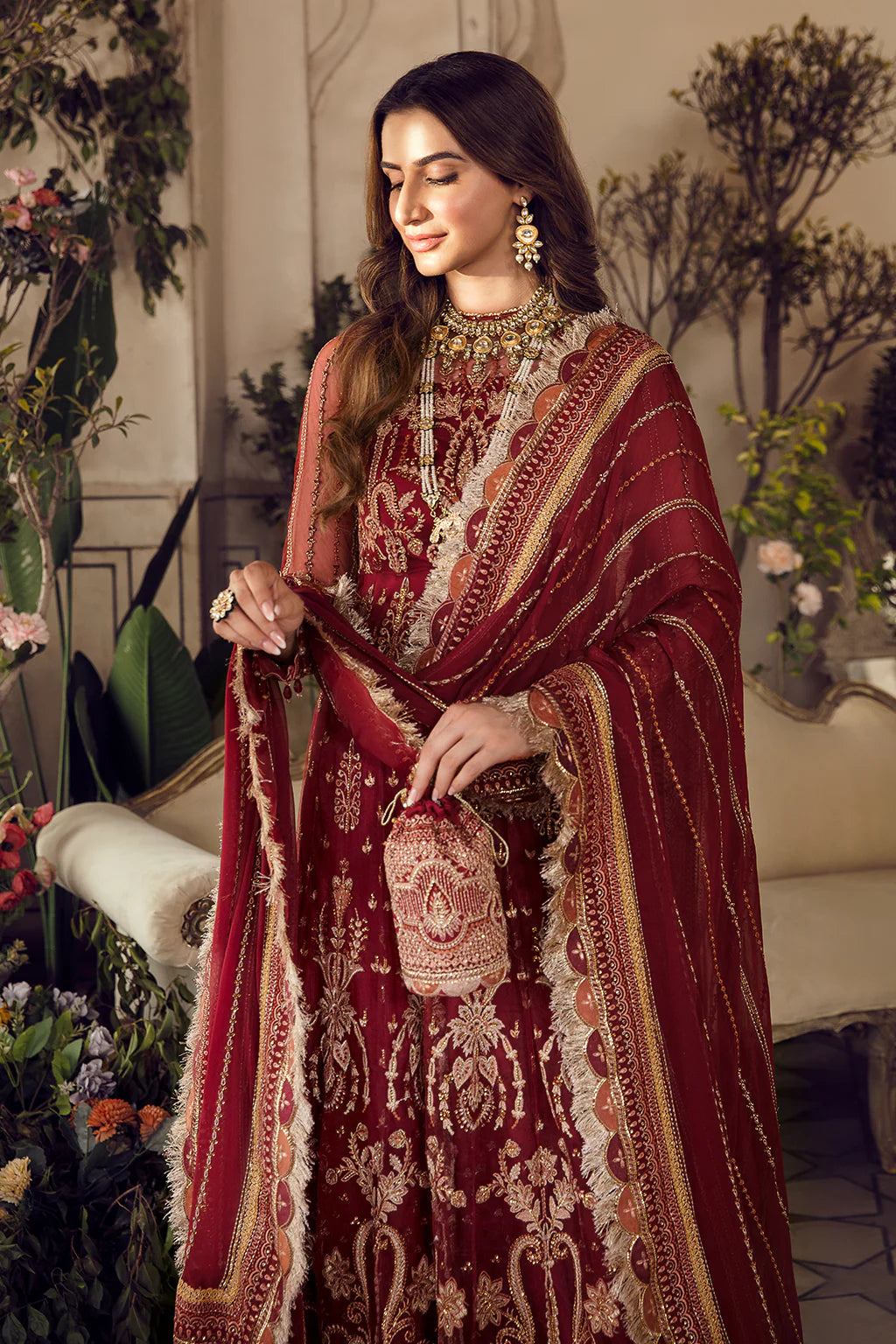 Currant Red embroidered Pishwas with gold zardosi detailing, chiffon dupatta, and raw silk trouser – perfect for festive and wedding wear.

