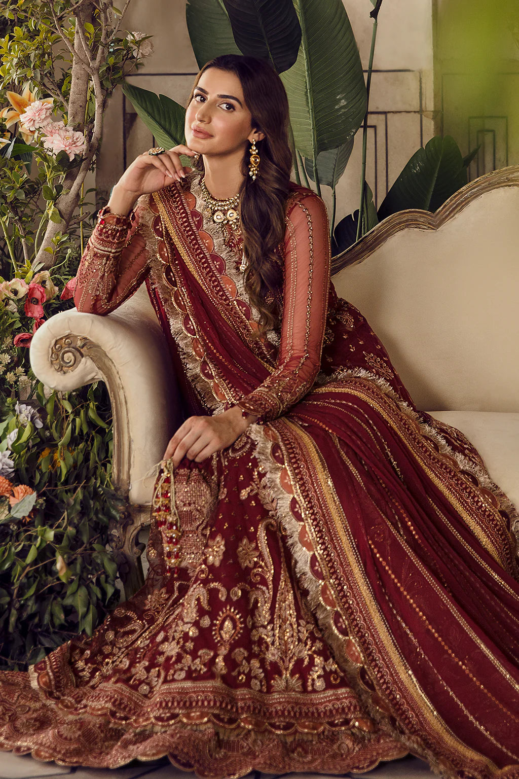 Currant Red embroidered Pishwas with gold zardosi detailing, chiffon dupatta, and raw silk trouser – perfect for festive and wedding wear.

