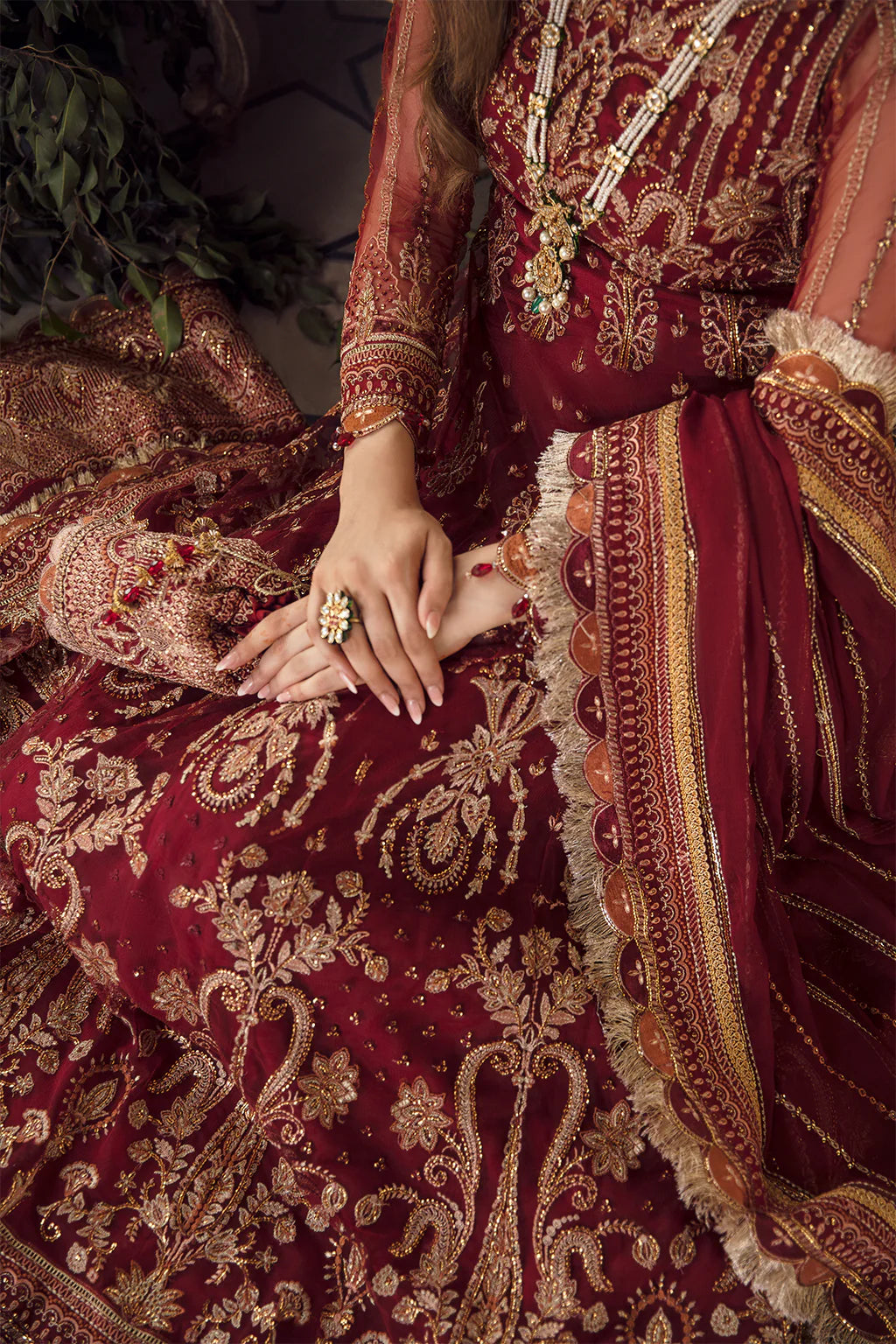Currant Red embroidered Pishwas with gold zardosi detailing, chiffon dupatta, and raw silk trouser – perfect for festive and wedding wear.

