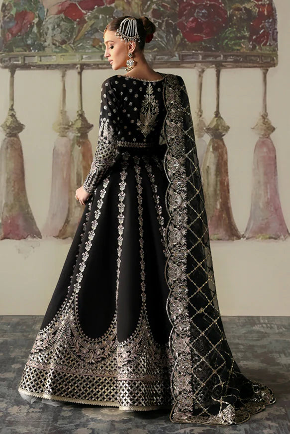 Husnara – Black raw silk lehenga choli with golden panni, tilla embroidery, sequins, and sheer embroidered dupatta.