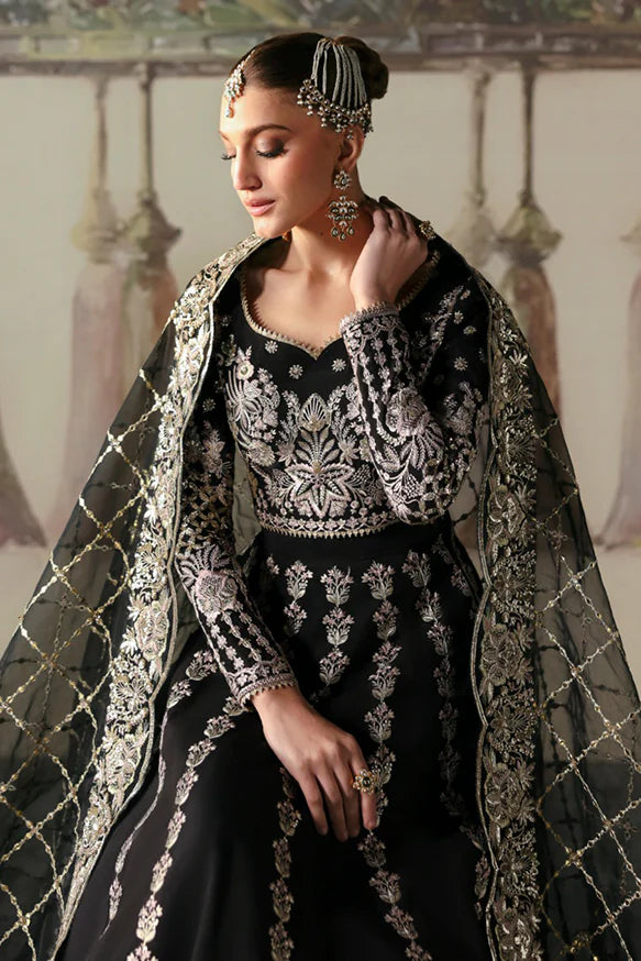 Husnara – Black raw silk lehenga choli with golden panni, tilla embroidery, sequins, and sheer embroidered dupatta.