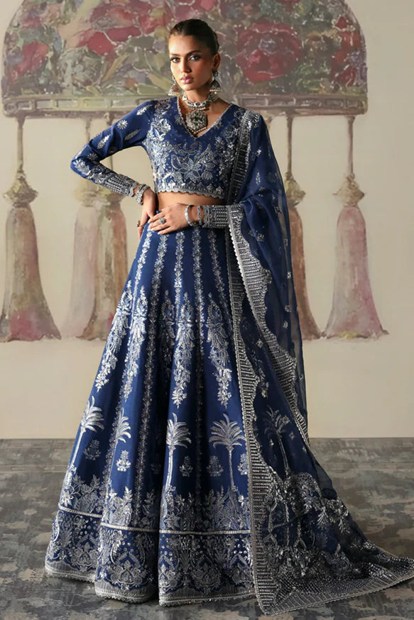 Nazli – Blue embroidered raw silk lehnga choli with sequins, tilla, and silver panni, paired with an embroidered organza dupatta.