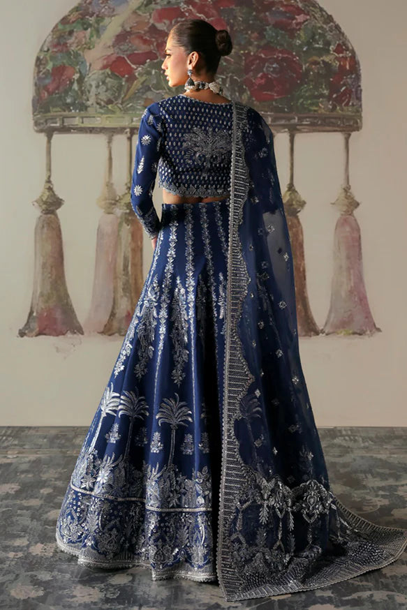 Nazli – Blue embroidered raw silk lehnga choli with sequins, tilla, and silver panni, paired with an embroidered organza dupatta.