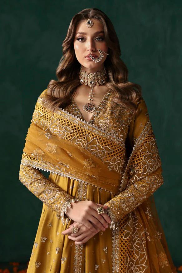 Jahanbano – Gold front-open peshwas with embroidered sharara, net dupatta, and raw silk trousers.