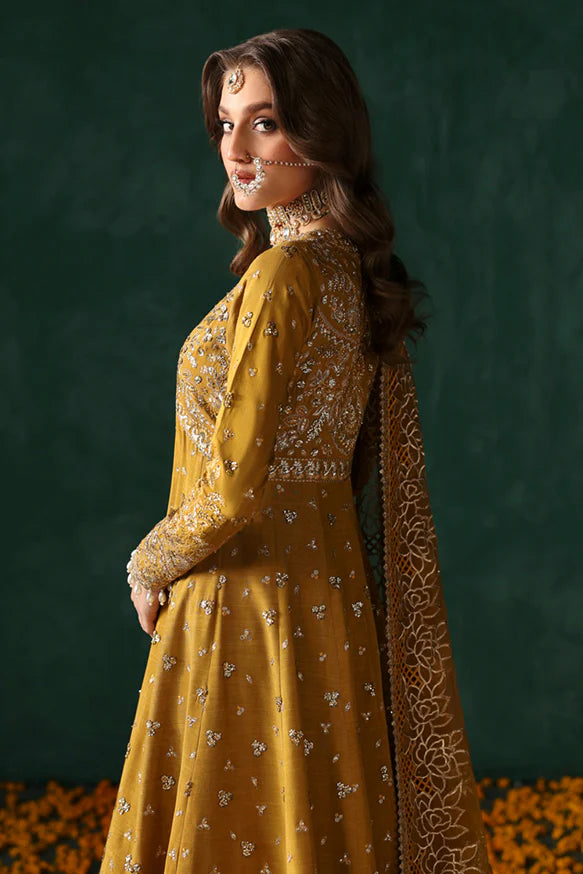 Jahanbano – Gold front-open peshwas with embroidered sharara, net dupatta, and raw silk trousers.